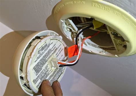 putting a battery smoke alarm over an electrical junction box|battery operated alarm over box.